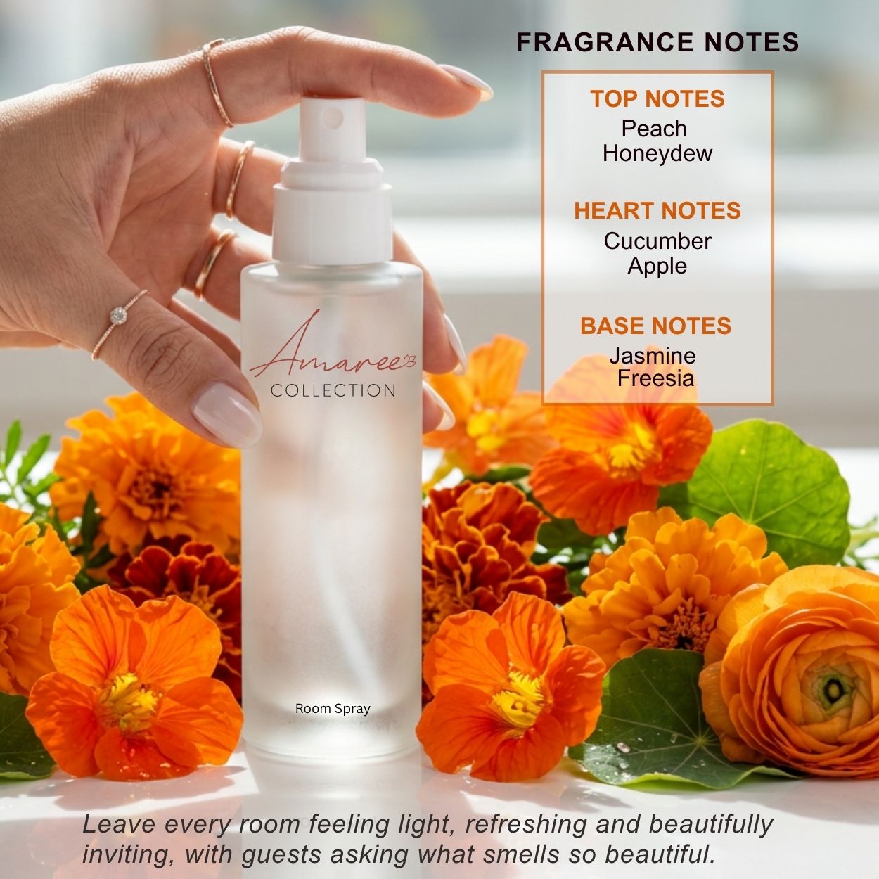 A hand holds a frosted glass room spray bottle labeled &