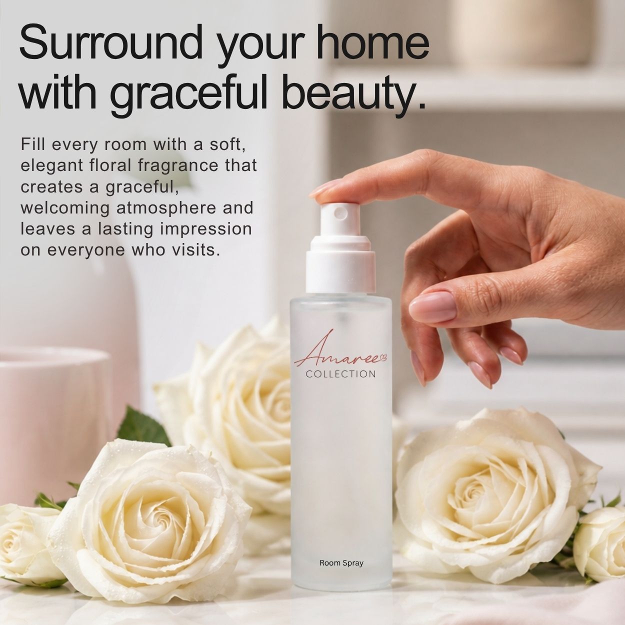 A hand sprays a frosted room spray bottle from the Amaree Collection, surrounded by white roses and set against a soft, blurred background with promotional text.