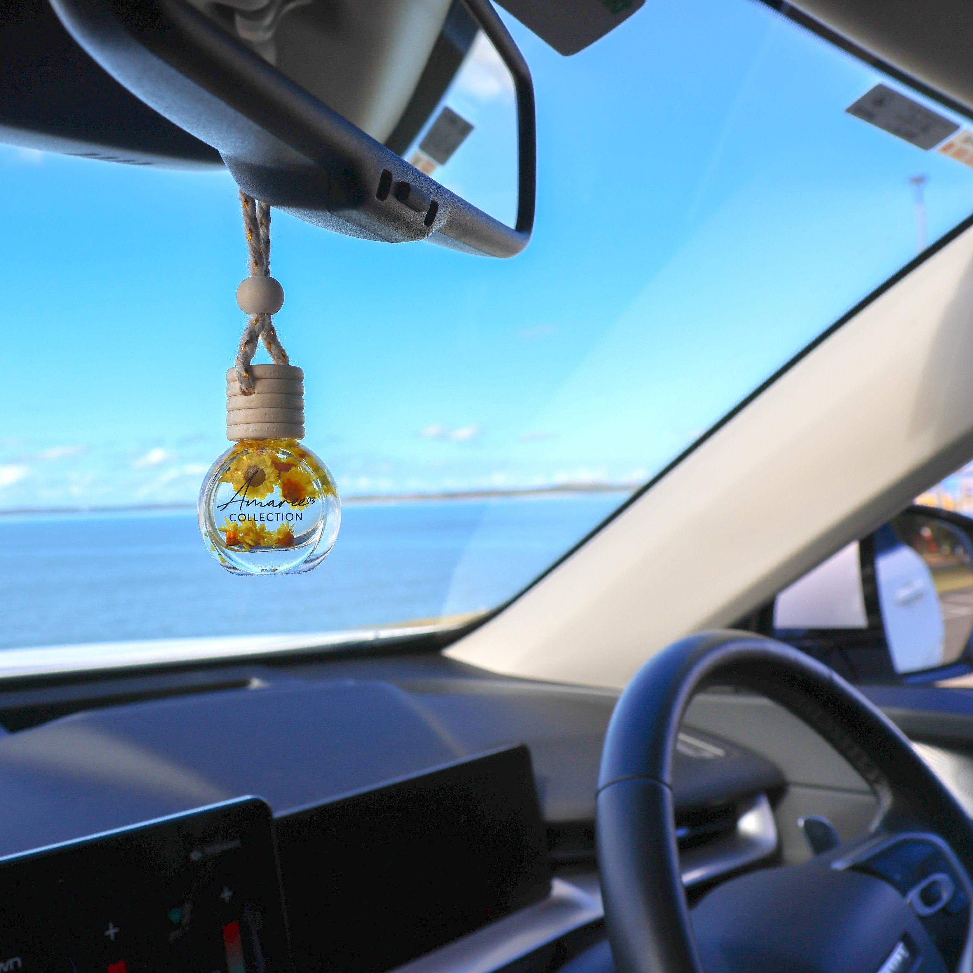 Vanilla, Patchouli &amp; Sandalwood Car Diffuser hanging from rearview mirror creating a warm, woody and sophisticated in-car atmosphere